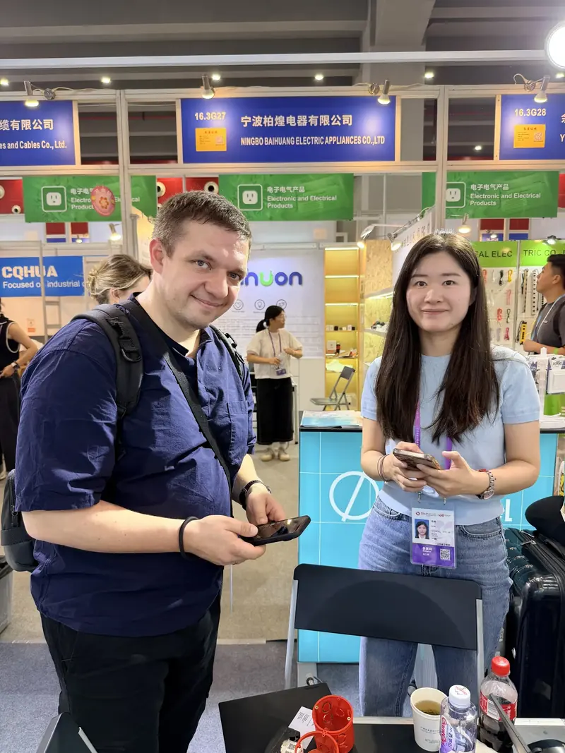 Glob-el team member talking with a visitor at the Glob-el booth during Canton Fair 2025