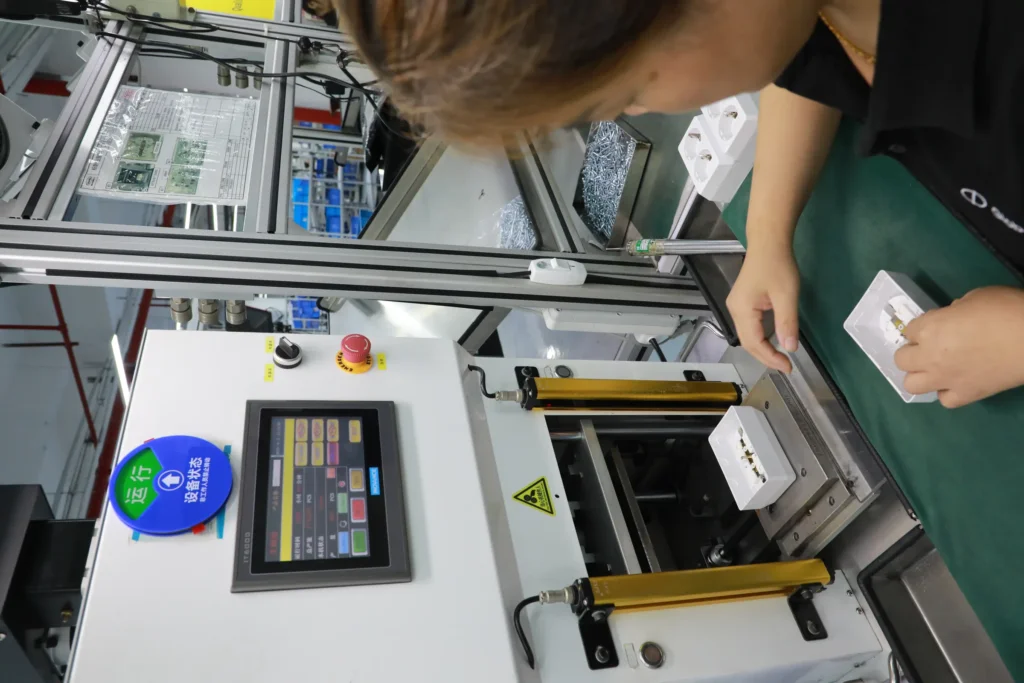 A line-side touchscreen showing running hours and total production count in pieces for the current order