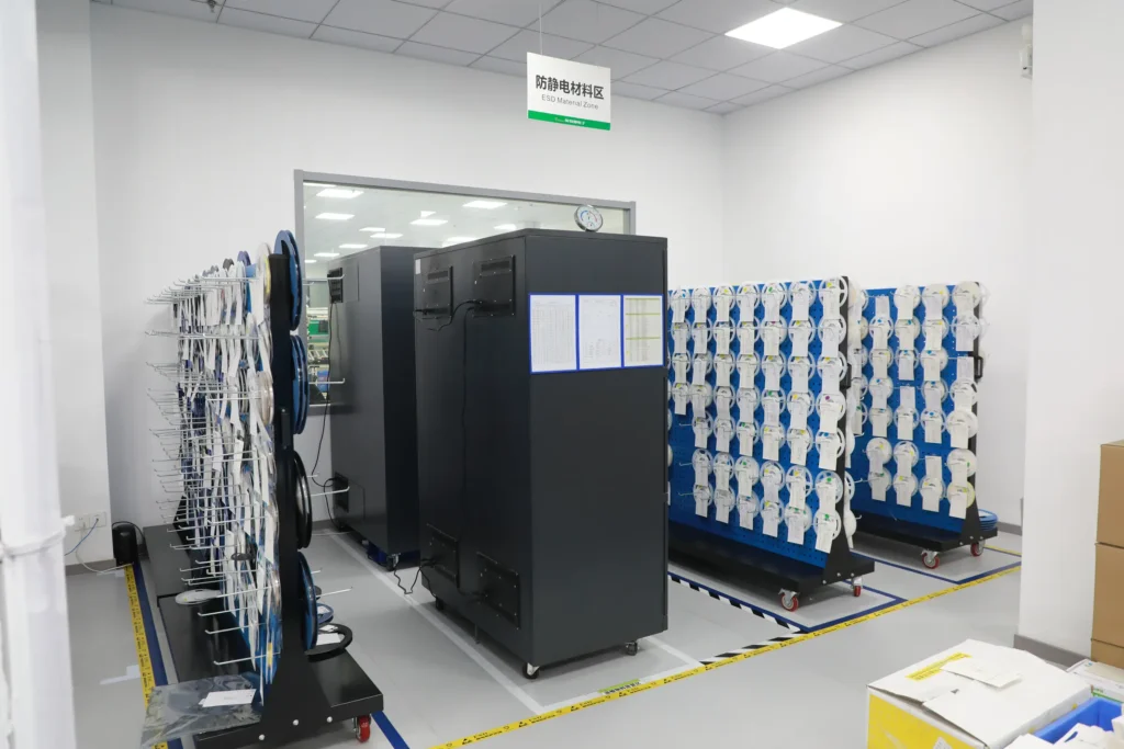 SMT electronics workshop ESD material zone with reels of surface-mount components staged on anti-static racks